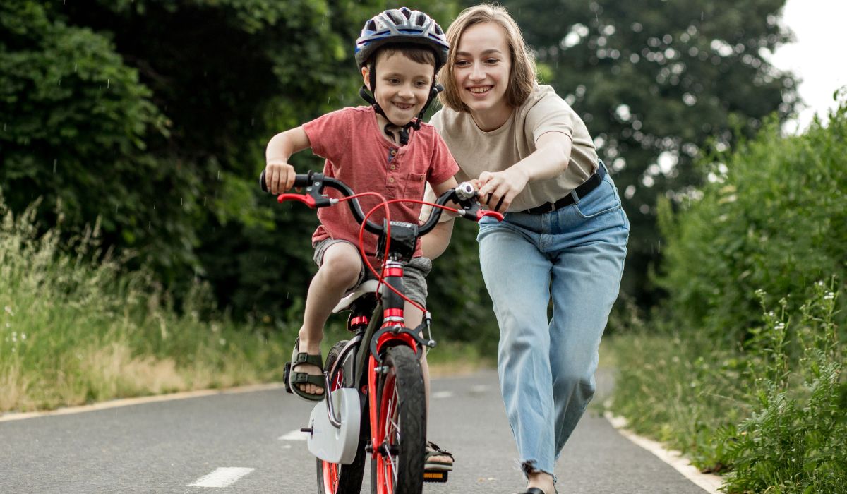 Mum teaching son how to ride a bike