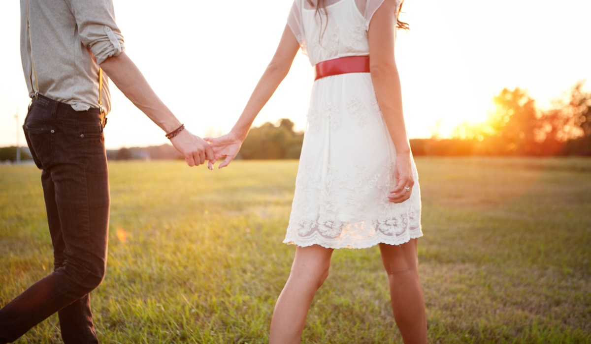 Young couple walking during sunset