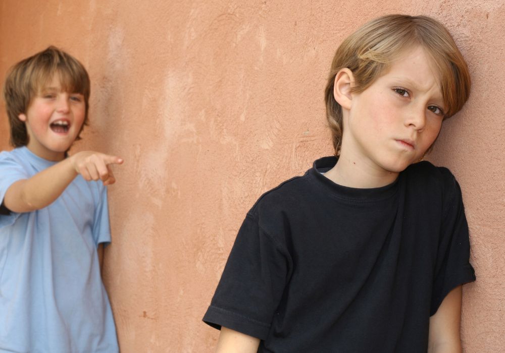 Bully teasing boy