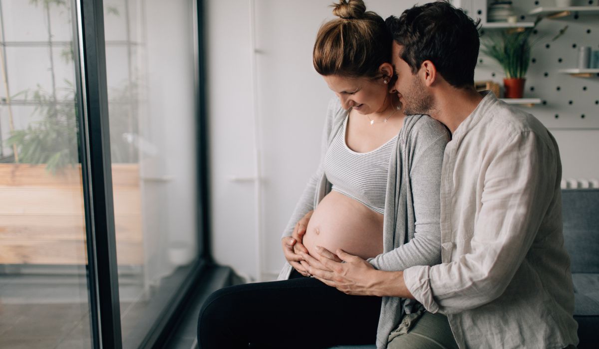 pregnant couple hugging