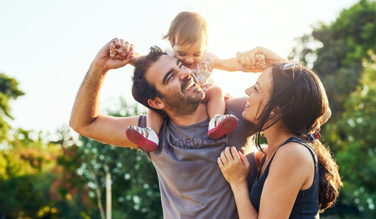 Happy, young family outside
