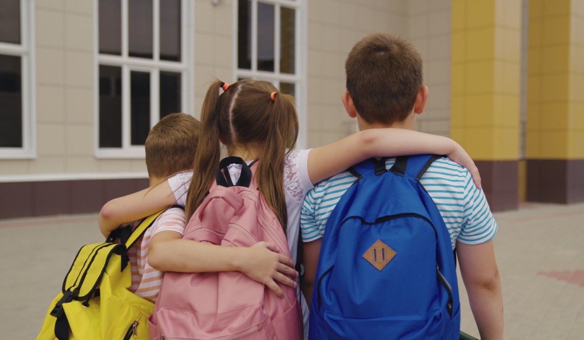 School children hugging each other
