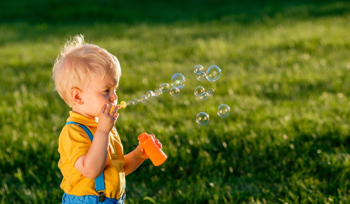 Little boy blowing bubbles