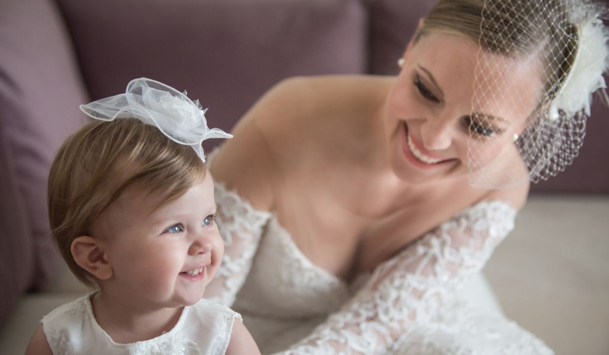 Bride and flower girl smiling
