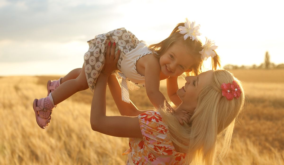 Mother and holding toddler in the air