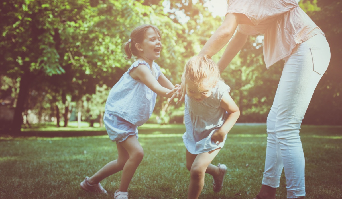 Mother playing with kids at the park