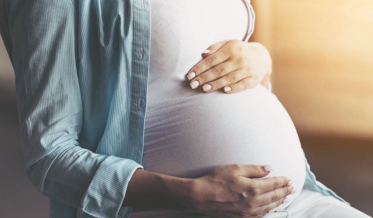 Pregnant woman holding belly