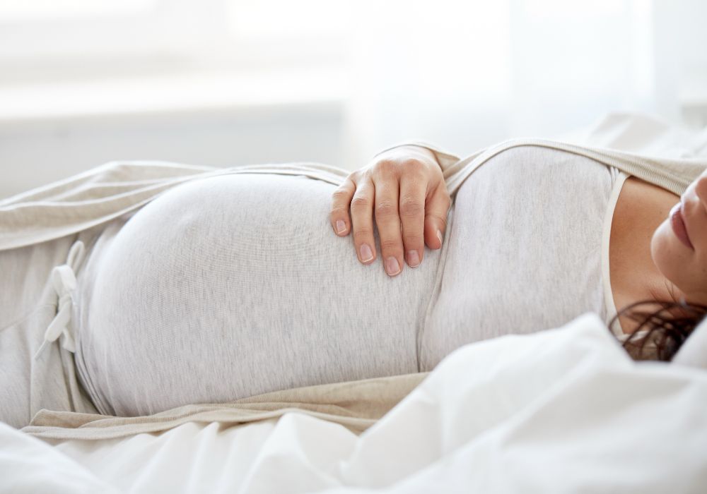 Pregnant woman lying in bed