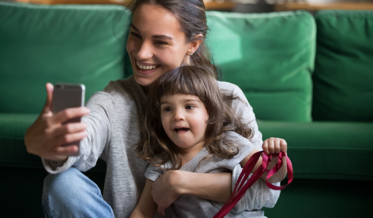 Mother taking selfie with daughter