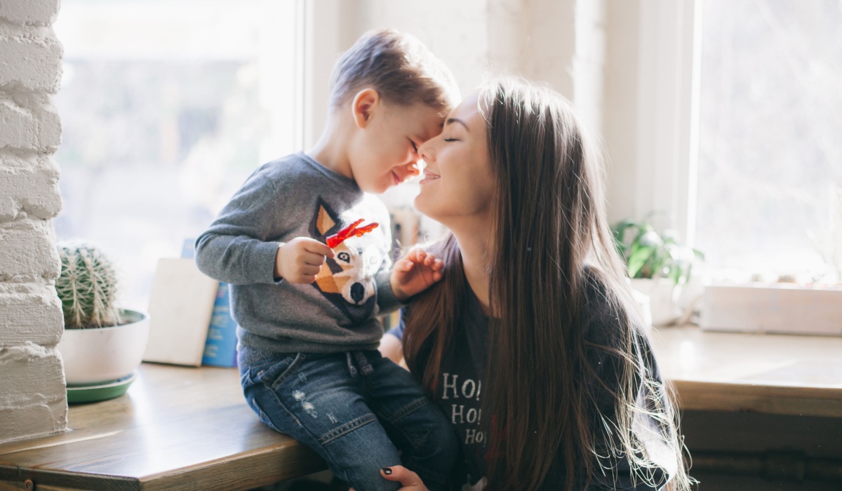 Mum being affectionate with young son
