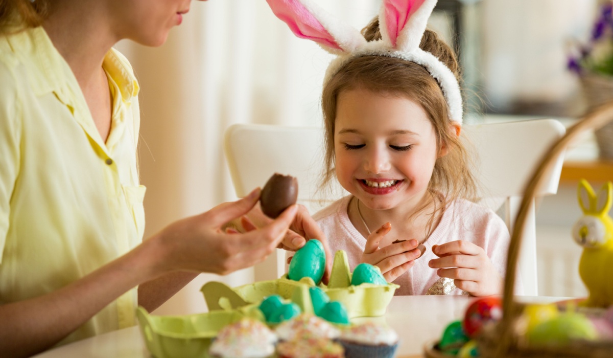 Little girl eating chocolate Easter eggs