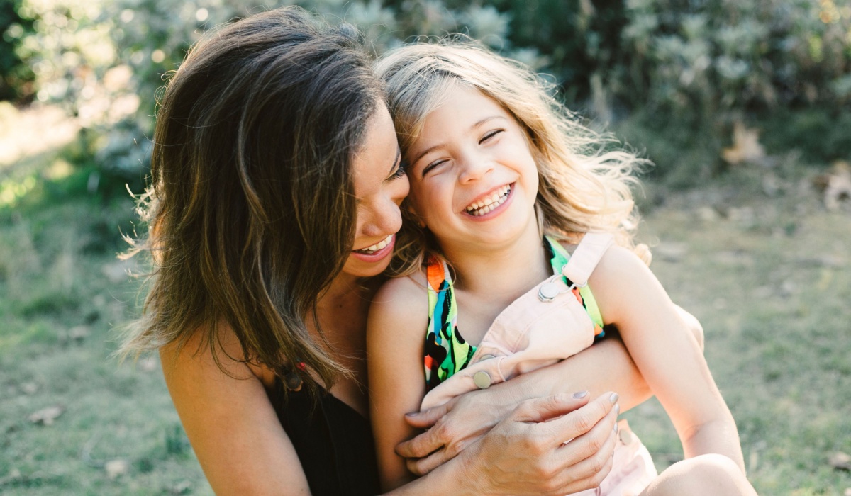Mum laughing with young daughter