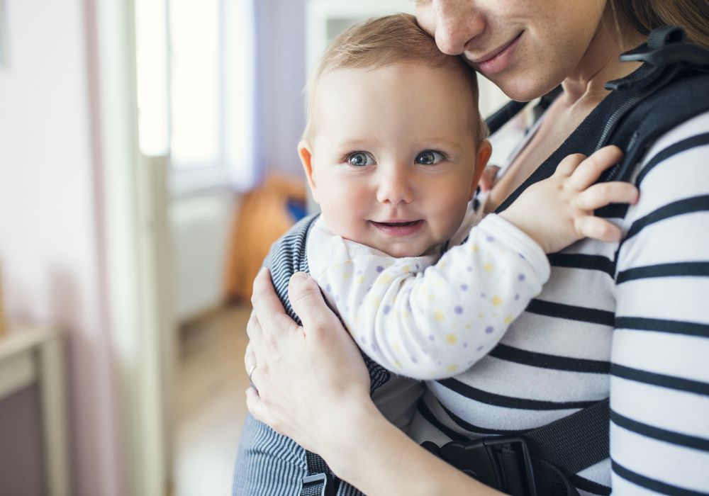 Baby being carried by mother