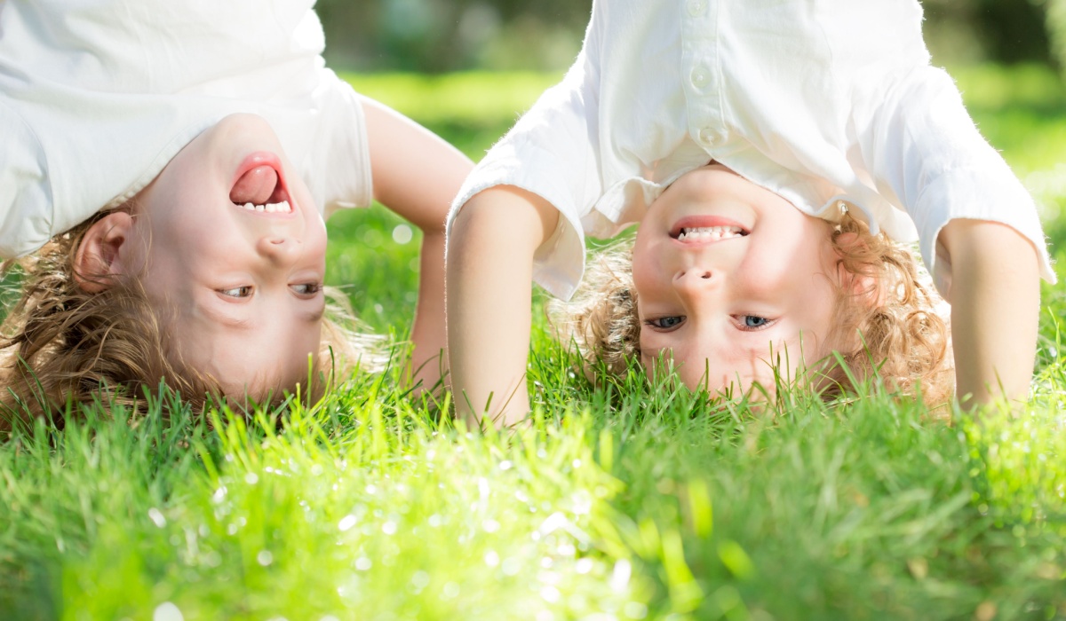 Two kids playing in the grass