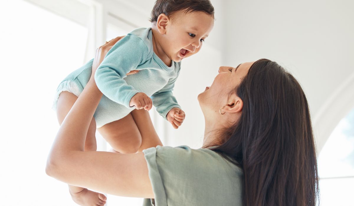 Mother holding baby in the air