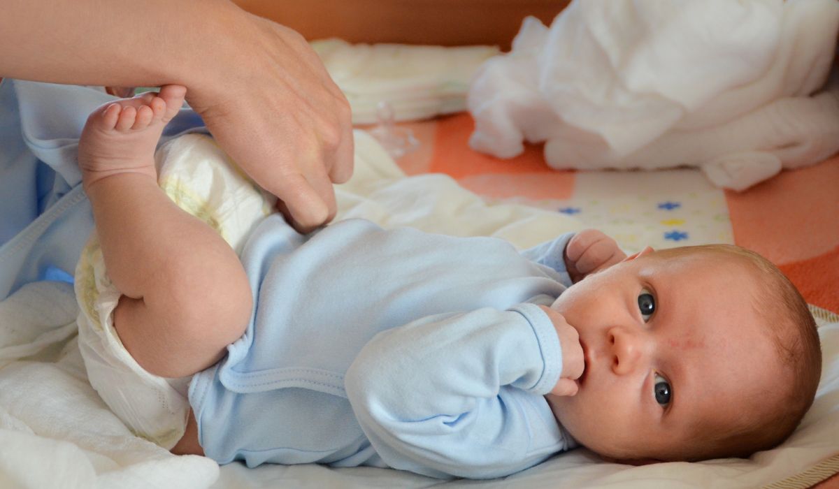 Parent changing baby's nappy