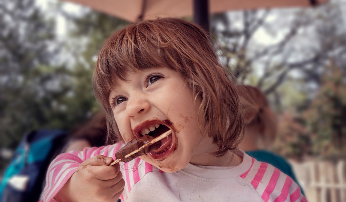 Little girl eating chocolate