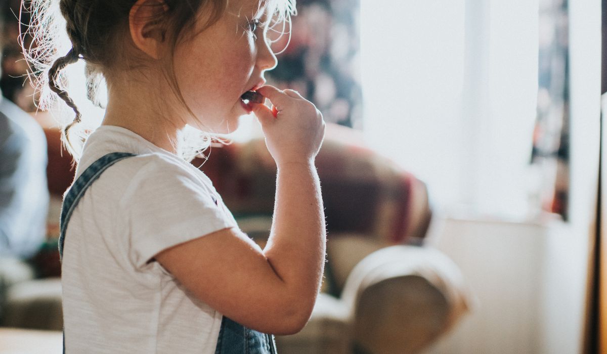 Little girl eating chocolate