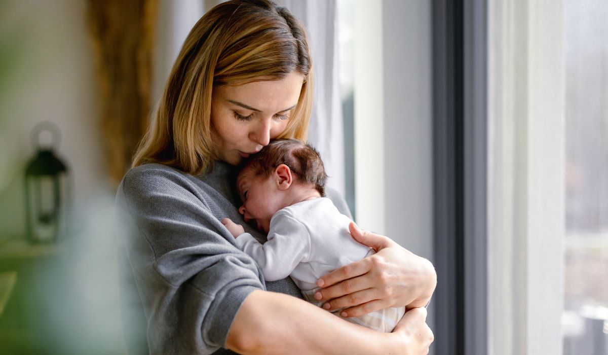 Woman kissing baby on head