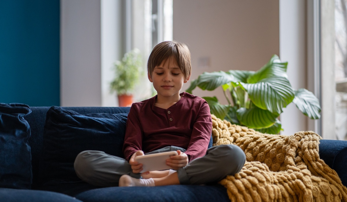 Young boy playing video game.