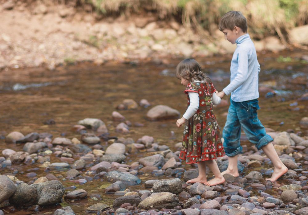 Kids playing in rocky river