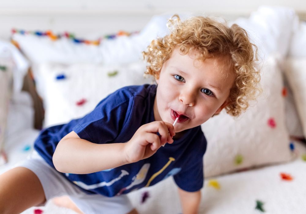 Little boy eating lollipop
