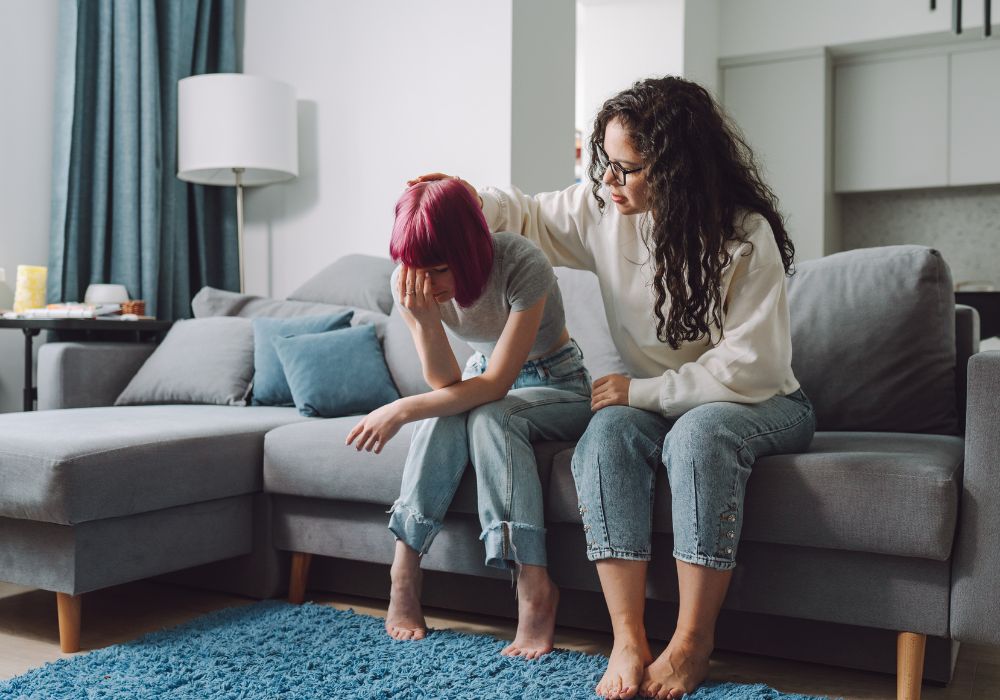 Mother comforting teenage daughter