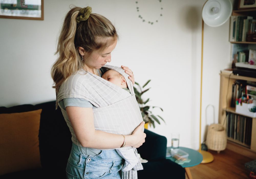 Mother with baby in carrier