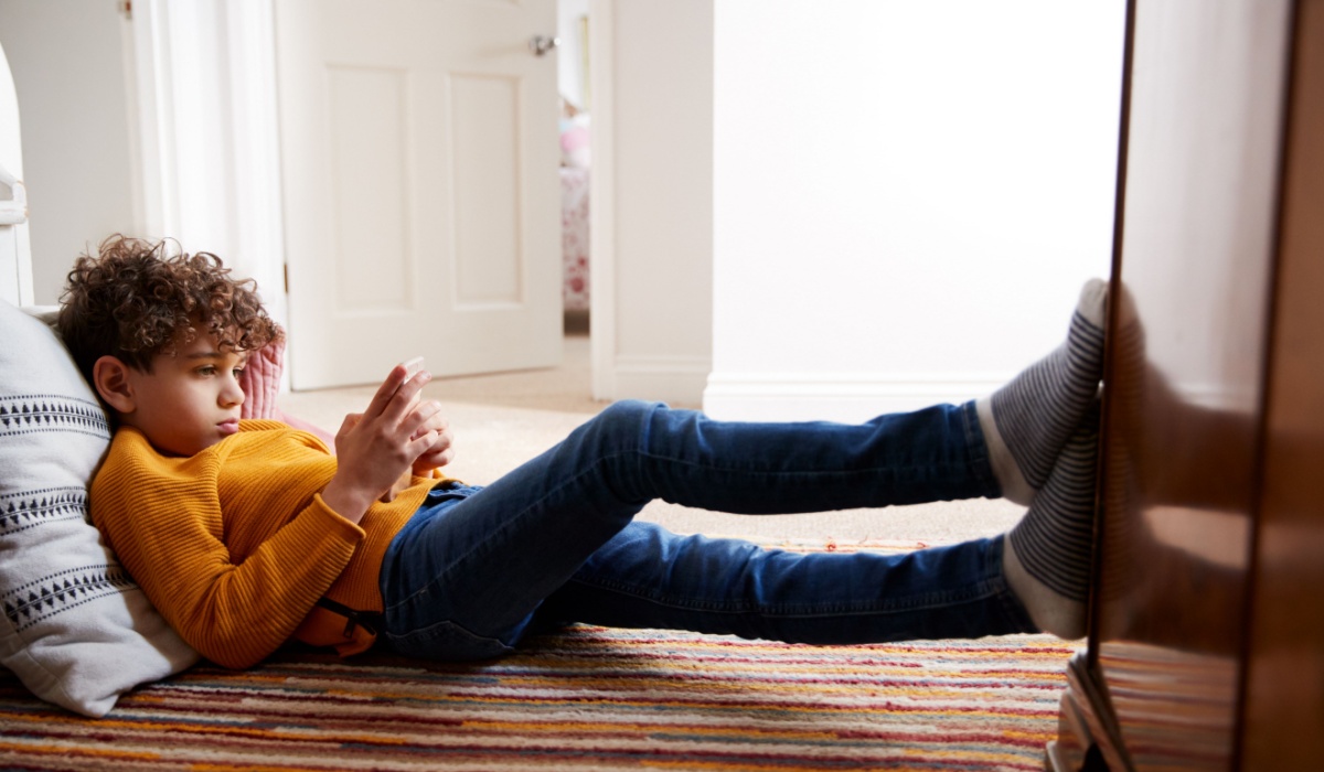 Tween boy looking at phone.
