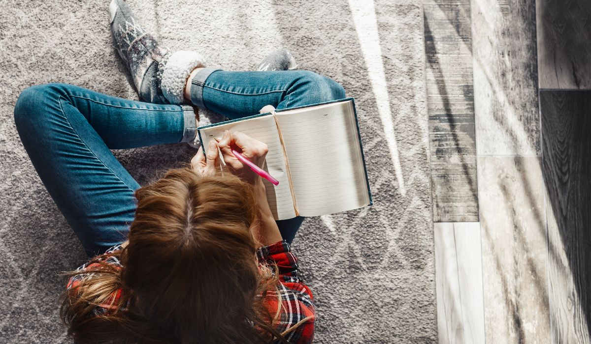 Teenage girl writing in journal