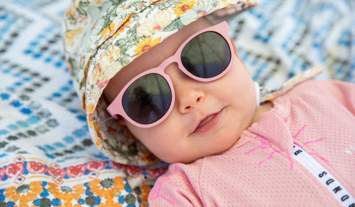 Baby in a Bonds Wondersuit wearing a hat