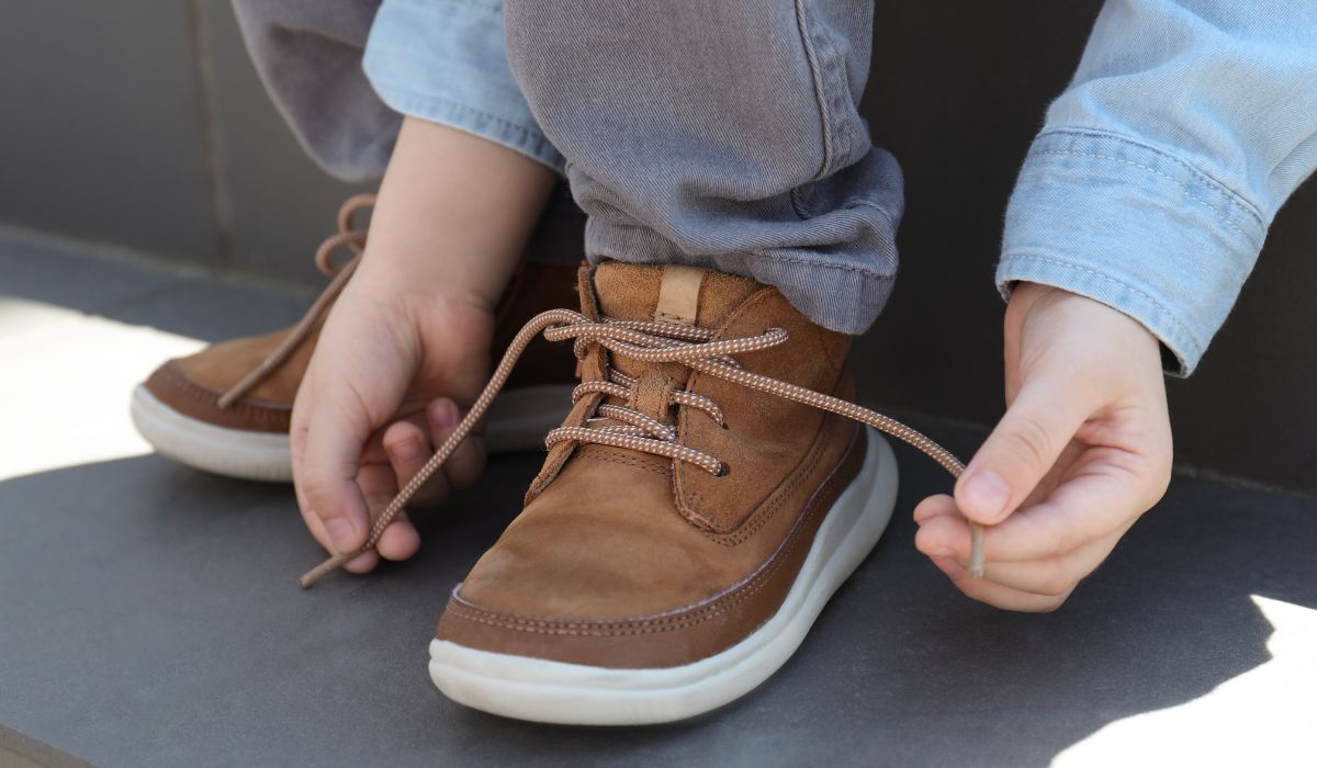 Child tying shoelaces