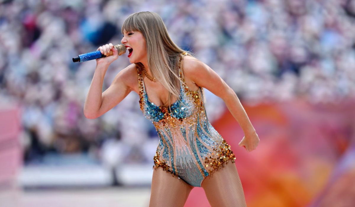 Taylor Swift performing a sparkly playsuit on her Eras Tour