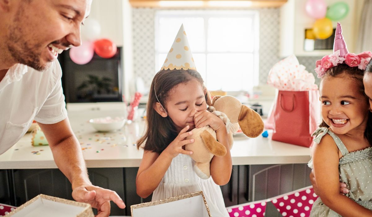 Little girl opening birthday gift
