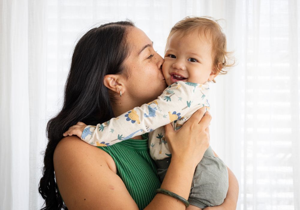 Mother kissing baby