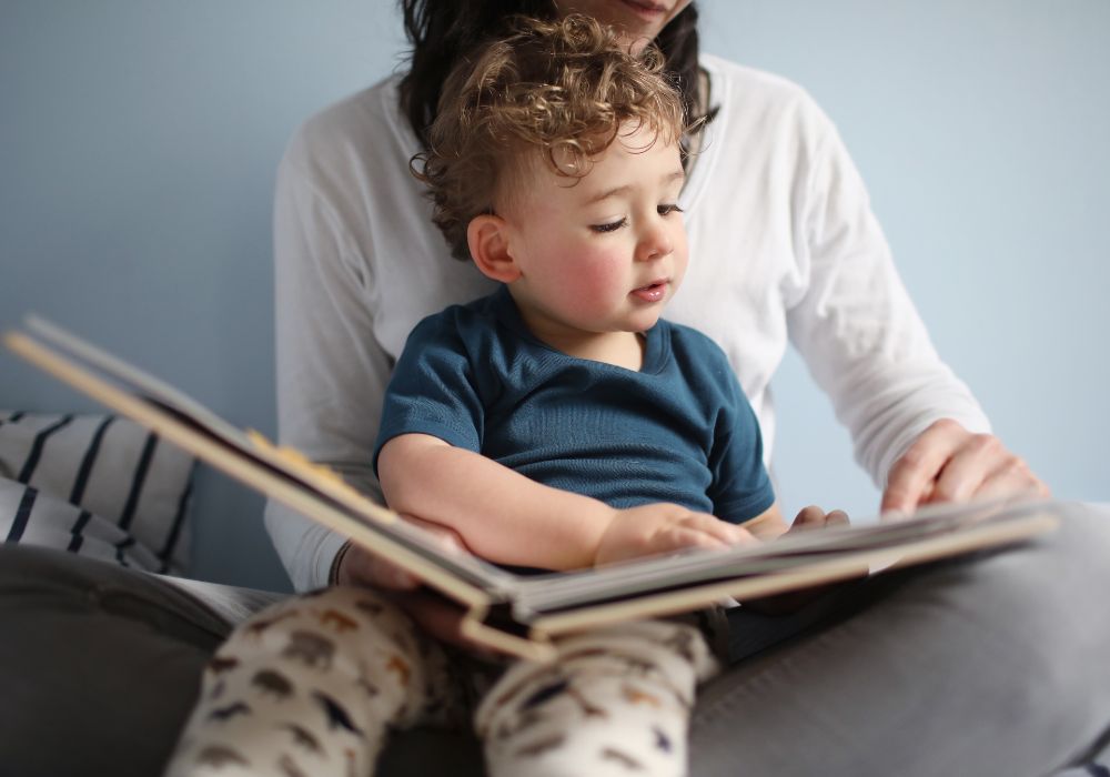 Mother reading book with baby