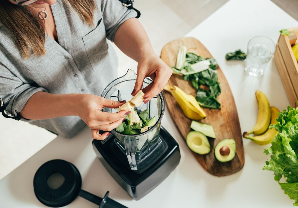 Woman making vegetable smoothie