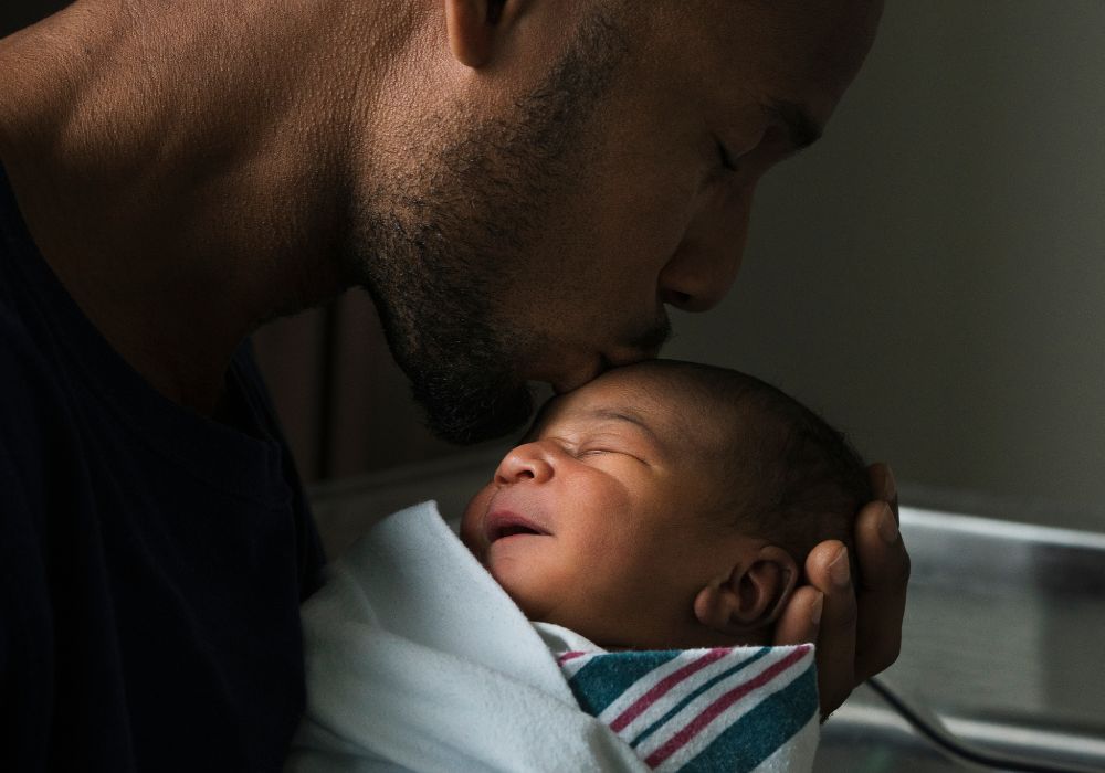 Dad kissing baby