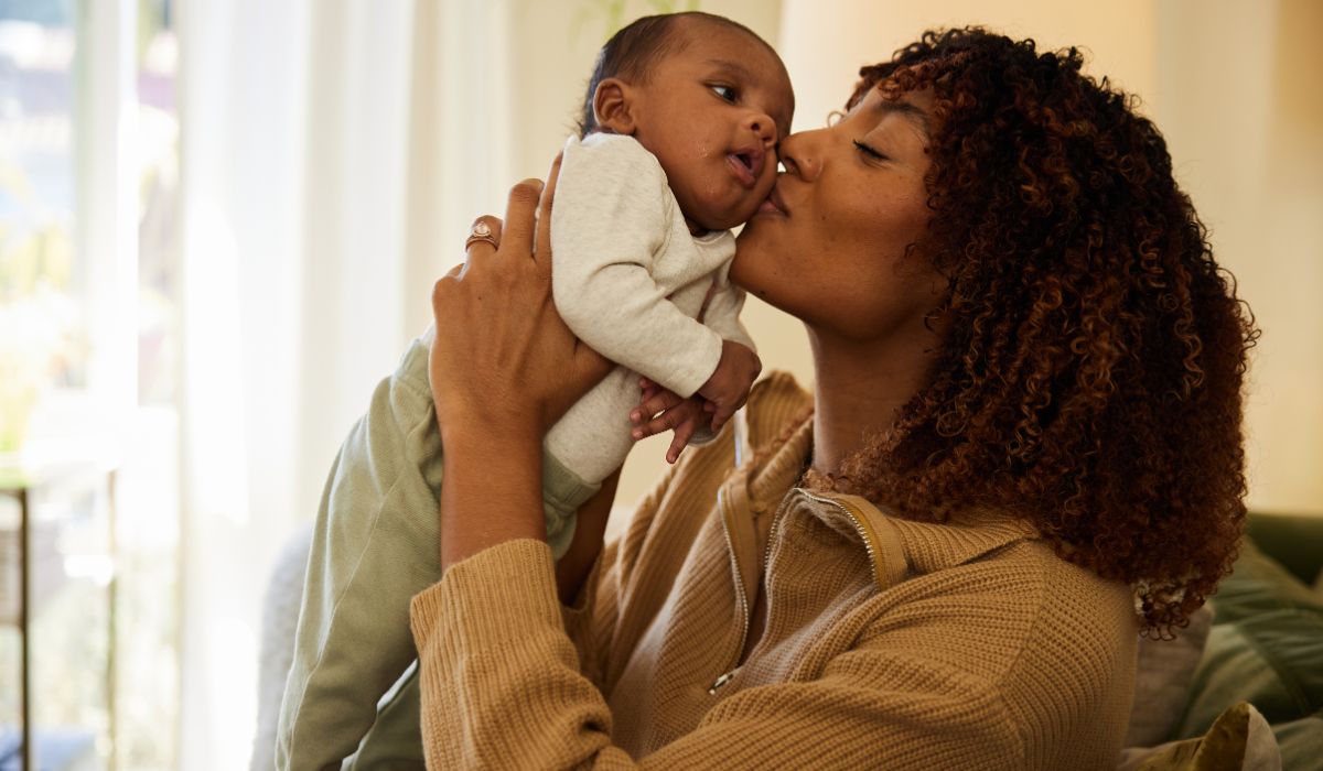 Mother kissing baby