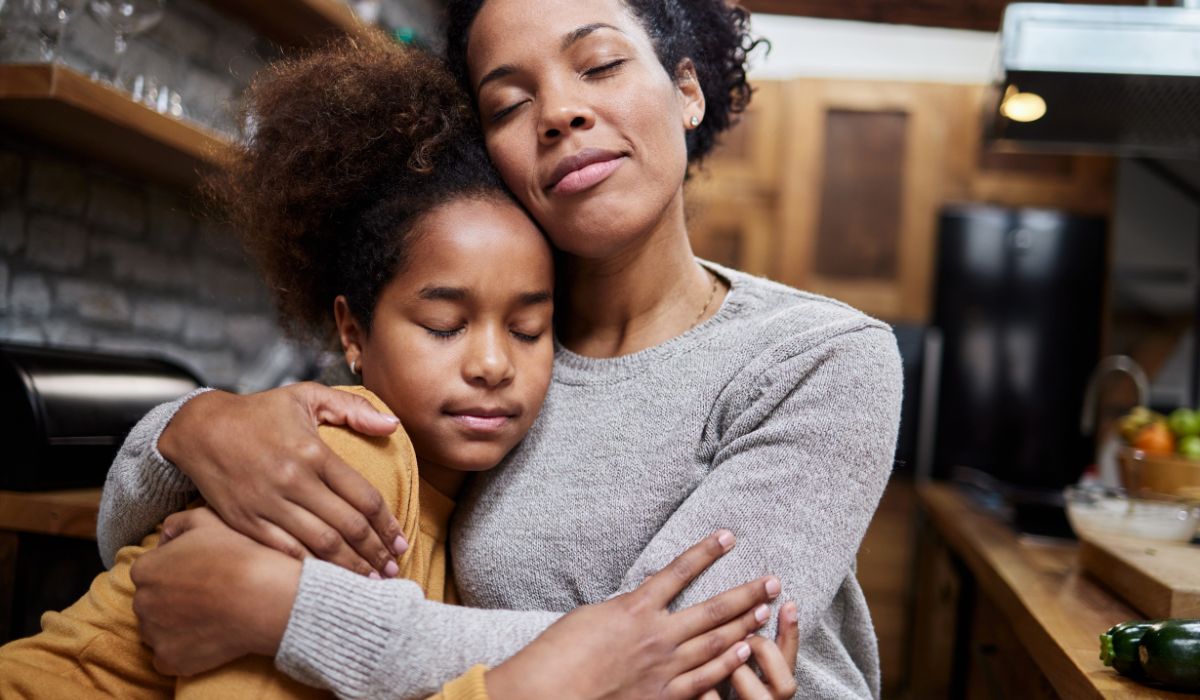 Mum hugging daughter
