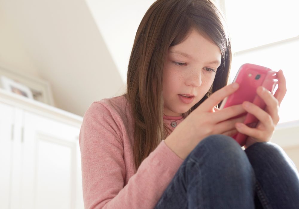 Tween girl looking at phone