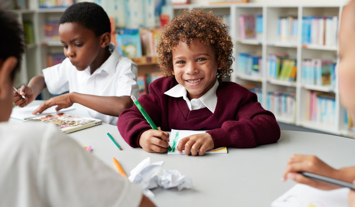 Little boy in school sitting at desk