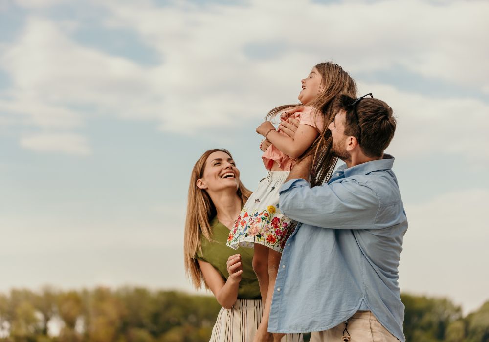 Parents and little girl outside