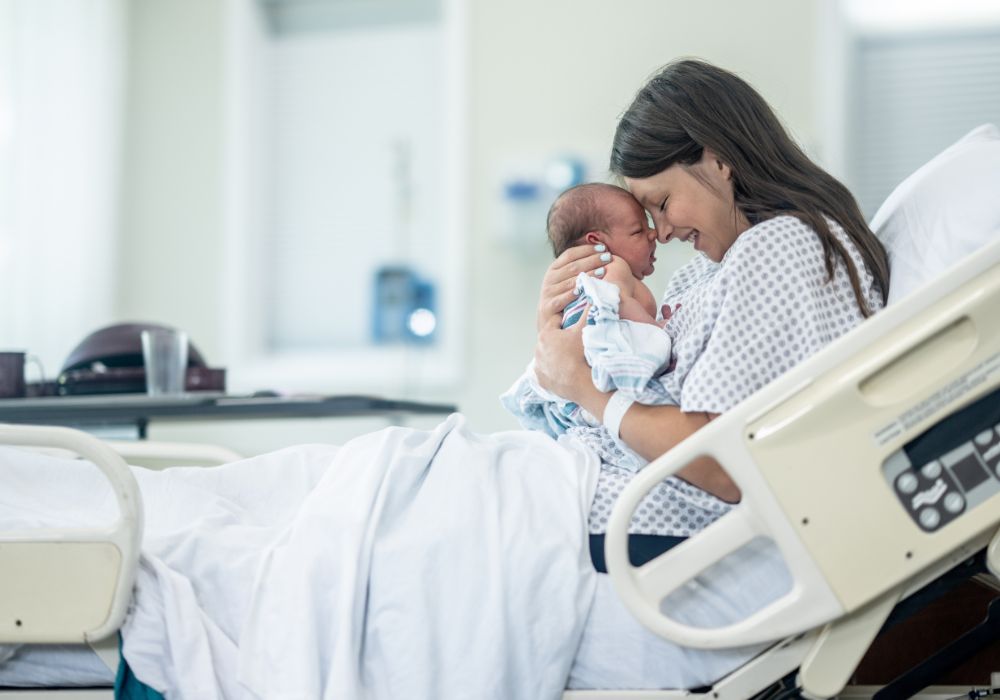 New mother holding up her baby before deciding on the baby name