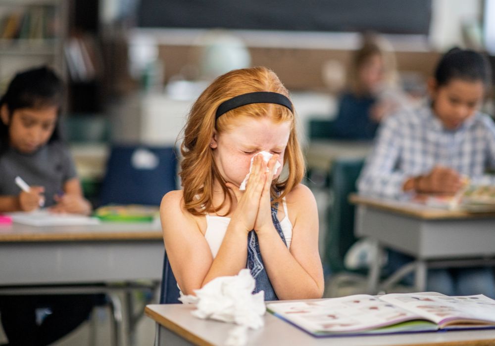 Child blowing nose in school
