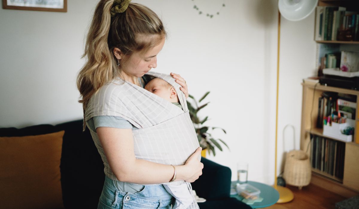 Mother carrying baby in sling