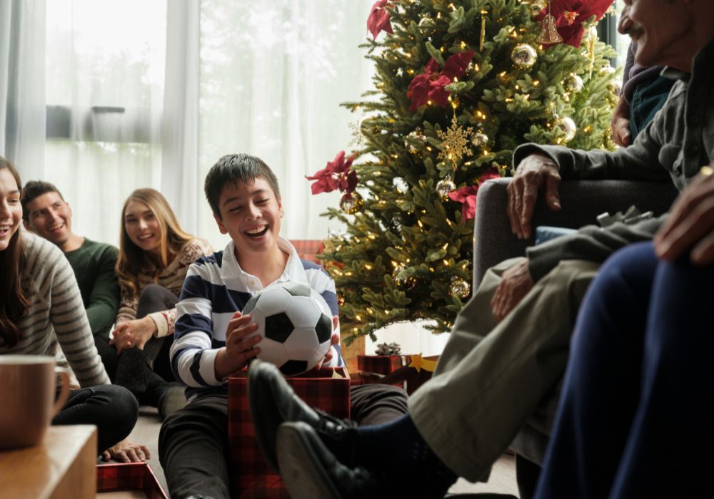Boy opens Christmas gift football