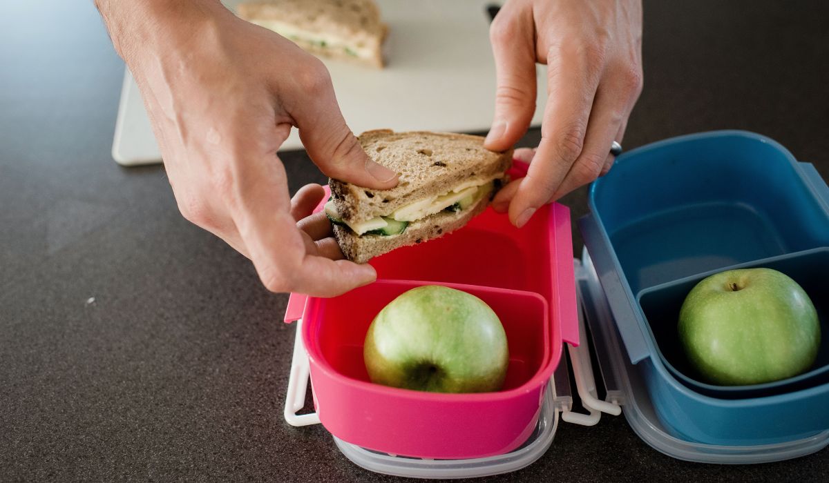 Parent packing children's lunch boxes for school
