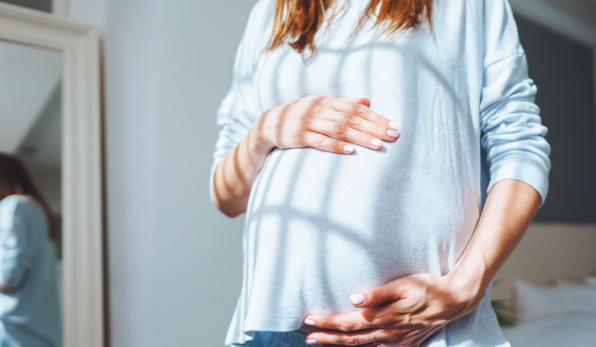 Pregnant woman holding bump