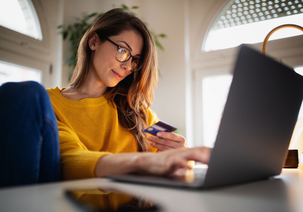 Woman online shopping and paying with credit card